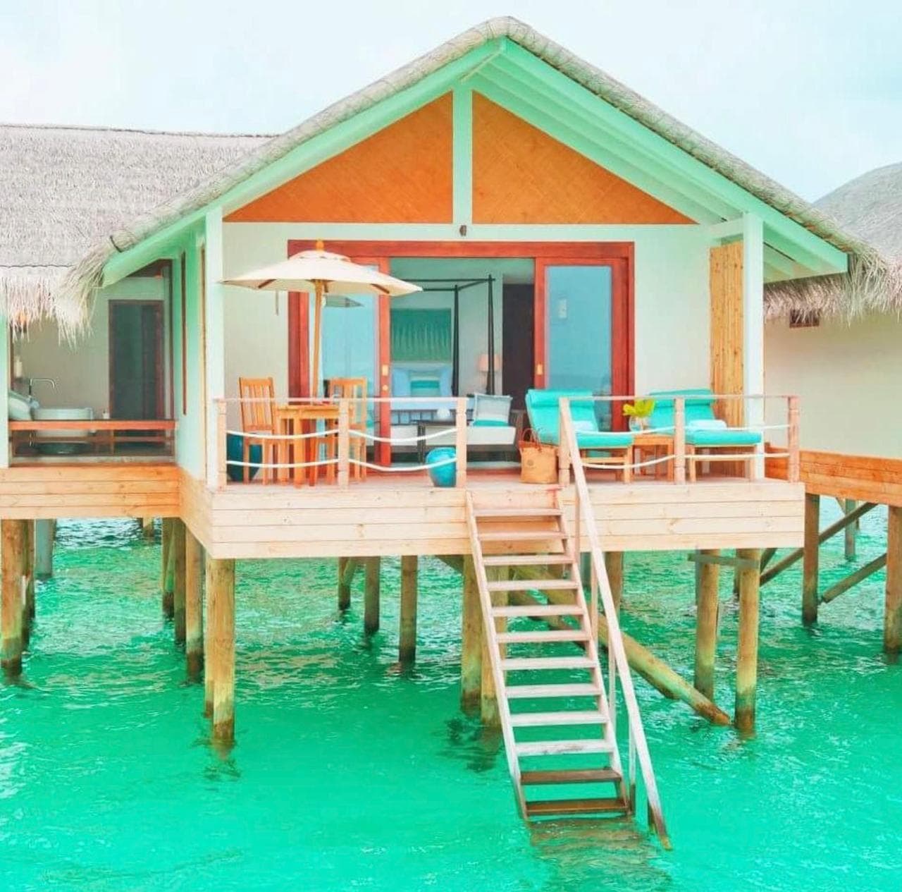An overwater villa at Loama Resort Maldives with steps down into the lagoon